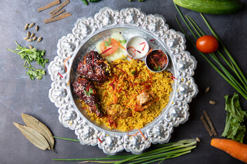 Tandoori Chicken Khichuri Platter with Glazed Chicken Pieces, Raita, and Salad on a Silver Silver Platter top view of bangladeshi food