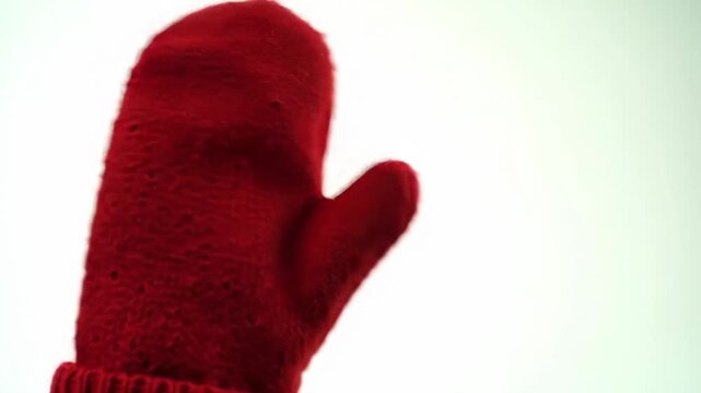Red mitten on white background, warm winter concept, for holiday advertisement or seasonal greetings