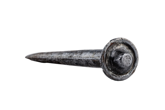 Close-up of a single, antique-looking nail.  Dark gray/black metal, pointed tip,  round head with a textured surface.  Isolated on black background