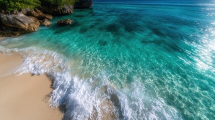 This vibrant image showcases a tropical beach where crystal clear turquoise water gently meets the sandy shore, creating a relaxing and inviting seaside atmosphere.
