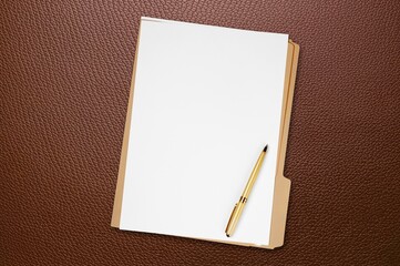 white and brown paper placed on desk