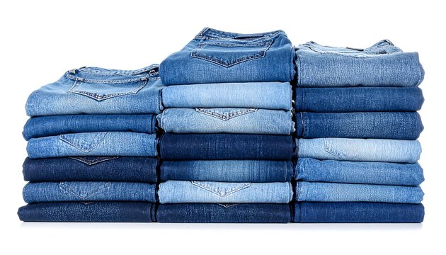 A stack of neatly folded denim jeans in varying shades of blue, arranged in a three-tiered configuration. The fabric textures and shadows are clearly visible