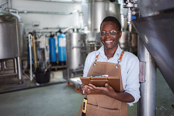Woman worker inspecting quality control in modern brewery