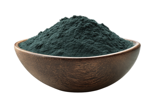 Dark-green powder in a wooden bowl. A heap of fine, dark teal-green powder fills a shallow, round, wooden bowl, presented against a plain black background. - Powered by Adobe