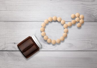 Medicine tablets in shape of male gender symbol