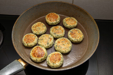 Cottage cheese pancakes or fritters with herbs, green onions, and parsley. Cottage cheese pancakes with dill on a plate. A healthy breakfast or a dietary lunch. Copy space.