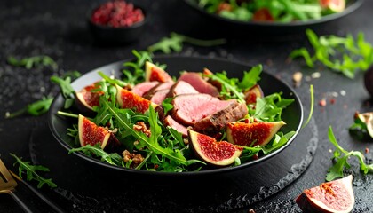 Plate of salad with figs, greens, and sliced cooked meat