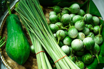 Lemon grass, Eggplant and Papaya in woven basket selling on the street market.