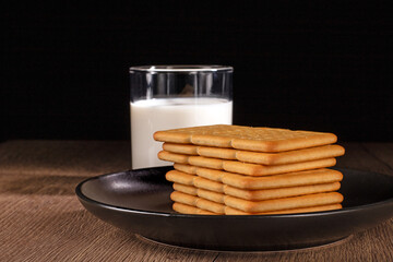 A glass of fresh milk and salty crackers enjoyed on a cozy kitchen table