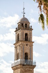 Naklejka premium The elegant bell tower of San Miguel Church in Jerez de la Frontera, Andalusia, Spain, standing under a bright blue sky