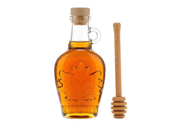Isolated maple syrup in glass bottle with cork stopper and honey dipper on plain studio