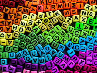 Alphabet beads arranged in a rainbow spectrum, showcasing vibrant colors.