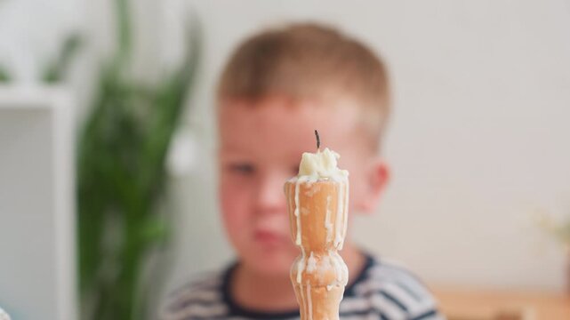 Close up of adult gently removing child hand from candle stand after extinguishing flame while special child sits nearby watching quietly during calm indoor moment showing care - Powered by Adobe