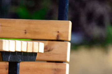 Wooden Park Bench with Metal Frame, Outdoor Seating in Public Park, Close-Up of Empty Bench for Relaxation