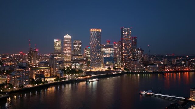 London Aerial Crane Shot of Canary Wharf Over River Thames with Illuminated Skyline
