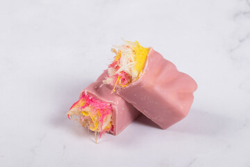 Pink chocolate candy bar. Angel Hair. With colored cotton candy. Light background. 