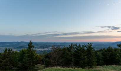 Panoramic view of valley town with mountains at sunset