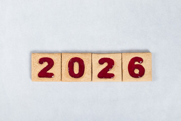 New Year 2026. Festive Square cookies with red marmalade filling in the shape of the numbers 2026. White background.