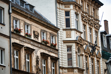 Ornate neoclassical architecture adorns the facade of a historic building, with vibrant floral displays adding a touch of vibrancy to the weathered stone walls.