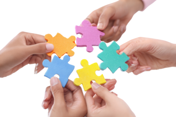 Diverse hands assemble colorful jigsaw puzzle pieces (1)