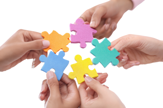 Diverse hands assemble colorful jigsaw puzzle pieces (1)