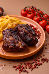 Grilled or barbecued pork ribs with sauce. Grilled ribs