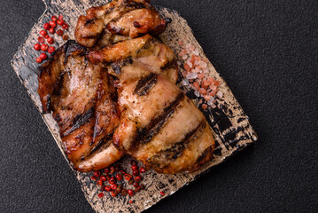 Chicken breast cooked on a grill or barbecue with sauce. Grilled chicken
