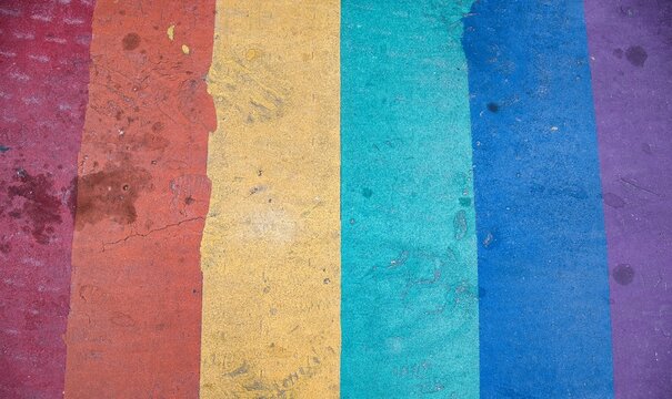 Vibrant abstract background of bold, textured color stripes in a rainbow palette.