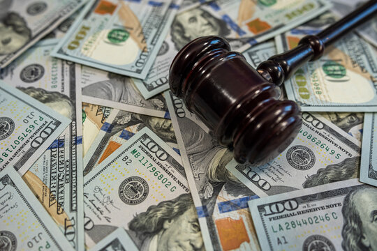 Judge's gavel on pile of US dollar bills &ndash; Concept of justice, corruption, bribery or court fines