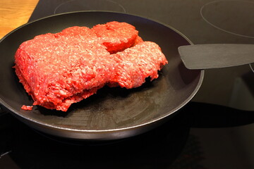 Minced meat in a frying pan on stove. Cooking concept.