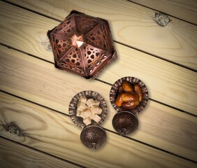 Ornamental Arabic lantern and dates on plate