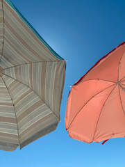 Sky view with two colorful umbrellas on the beach