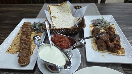 Traditional georgian cuisine display with shaslik, kebab, and sauces for culinary enjoyment