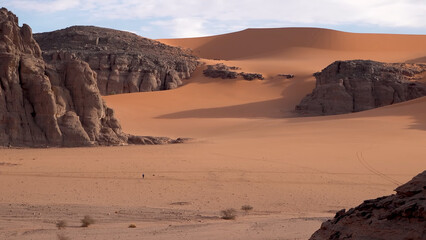 A trip to Sahara desert in Algeria. Beautiful 
african travel photo. Sandy landscapes, mountains, rocks,
dunes, and nature. Summer vacation in arab country.