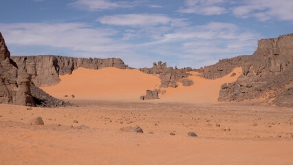 A trip to Sahara desert in Algeria. Beautiful african travel photo. Sandy landscapes, mountains, rocks, dunes, and nature. Summer vacation in arab country.