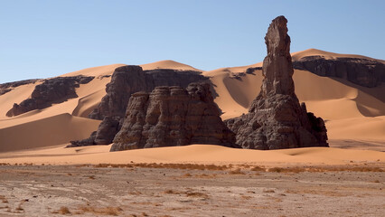 A trip to Sahara desert in Algeria. Beautiful 
african travel photo. Sandy landscapes, mountains, rocks,
dunes, and nature. Summer vacation in arab country.