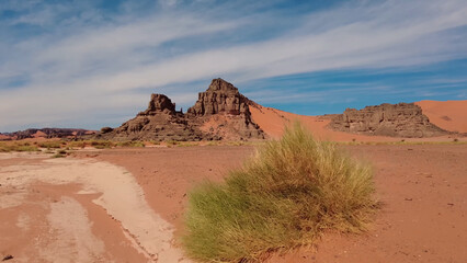 A trip to Sahara desert in Algeria. Beautiful 
african travel photo. Sandy landscapes, mountains, rocks,
dunes, and nature. Summer vacation in arab country.