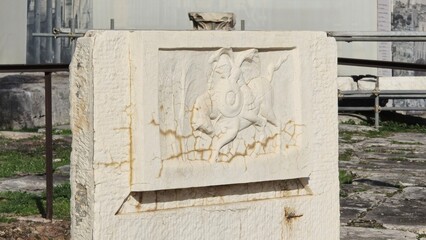 Rome, Italy - 13 January 2025. The Lacus Curtius site features a weathered stone with a dynamic relief of a falling horseman carved in shallow depth.