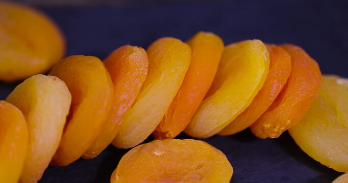 dried ripe orange apricot fruits on a slate board, dried seedless pure dried apricots for long-term storage and used as a sweet or for making compotes