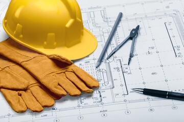 Hard hat and architectural drawings on the desk