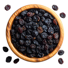 Overhead view of wooden bowl filled with dried, dark grapes against a black background
