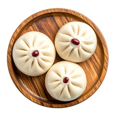 Overhead shot of three steamed buns with red bean centers on a wooden plate