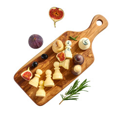 A wooden serving board with cheese arranged with figs, grapes, rosemary, and more
