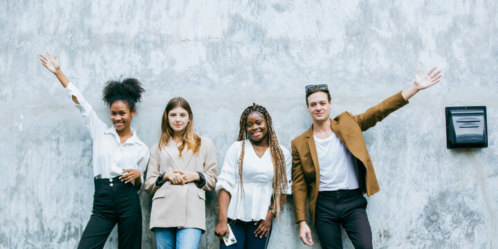 Portrait of creative marketing team of young diverse professionals standing together outdoors, showing confidence, teamwork, leadership, and collaboration in modern business environment