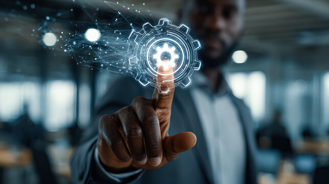 Businessman engages with a digital gear interface, representing technology and innovation in a modern workspace, emphasizing efficiency and professional development
