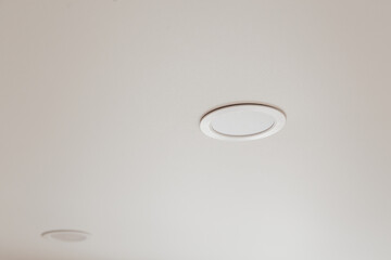 White stretch ceiling with spot lights in room