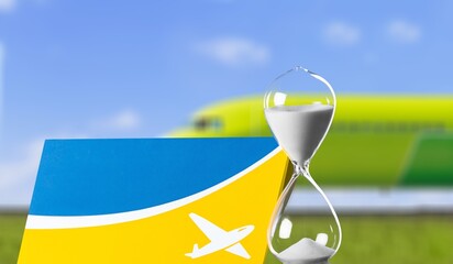 Old glass sand clock and plane ticket