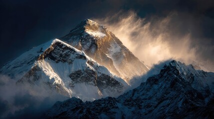 Majestic snow capped mountain peaks illuminated by golden sunlight