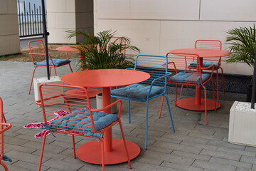 A Vibrant and Inviting Outdoor Seating Area Featuring Colorful Tables and Cozy Chairs