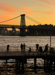 People by the pier on the Brooklyn waterfront during sunset